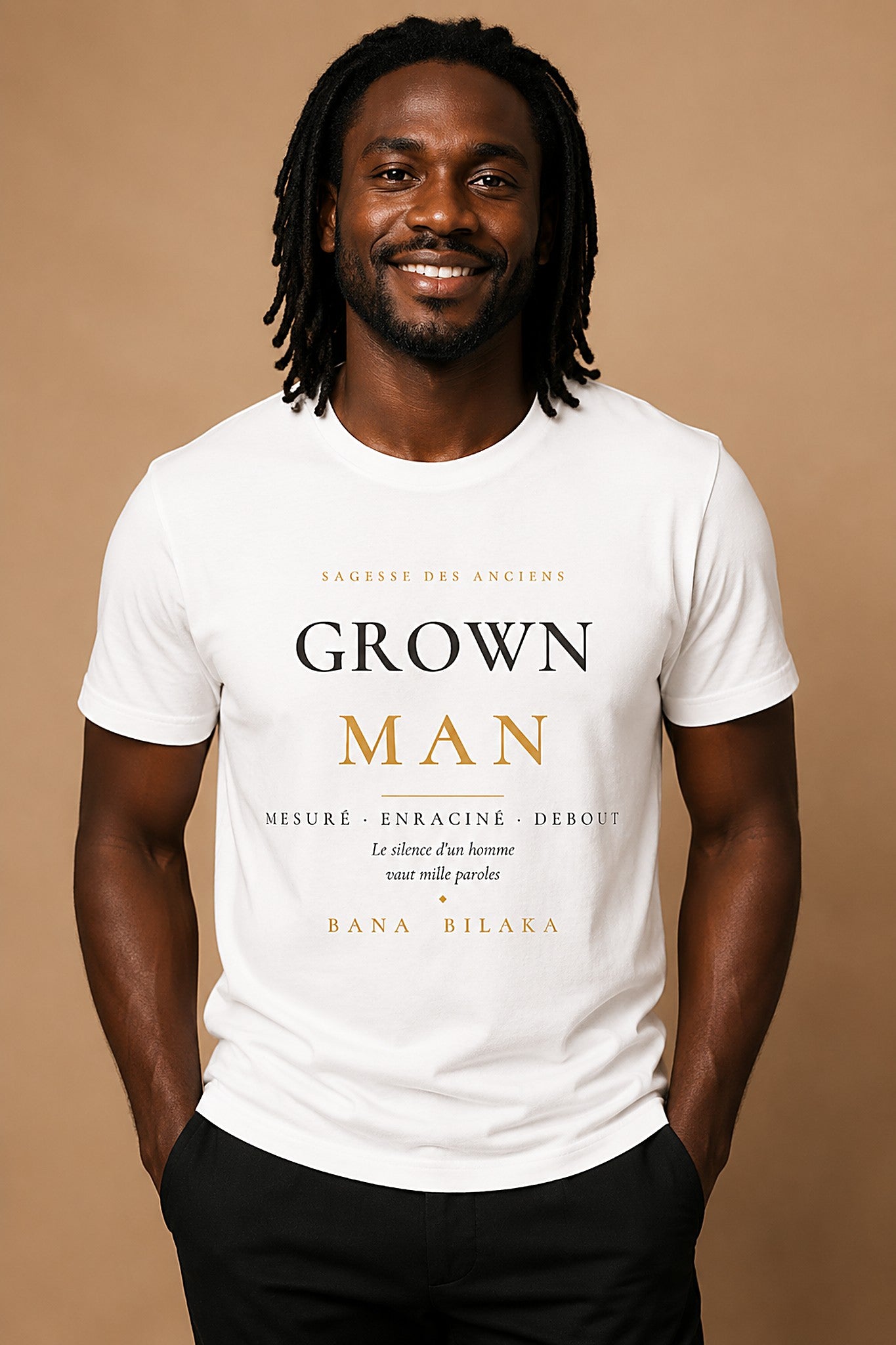 Bana Bilaka Grown Man — premium white organic cotton men's tee worn by a Black man with dreadlocks, editorial portrait