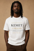 Bana Bilaka Kemet l'Origine — premium white organic cotton men's tee worn by a Black man, editorial portrait