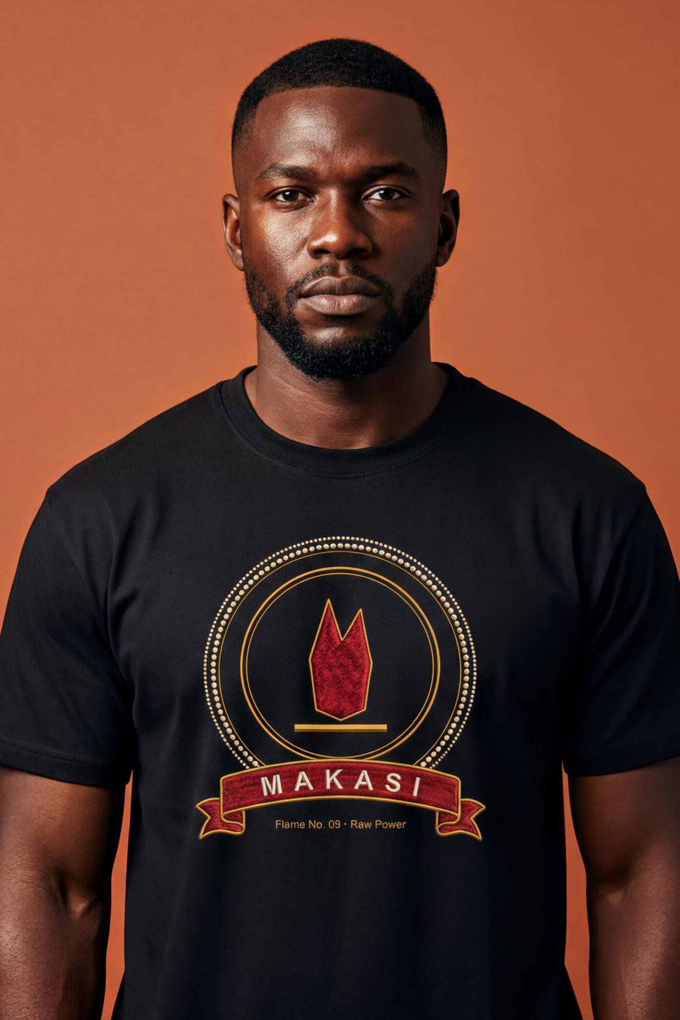 Strong man wearing the black Makasi tee, wide ruby flame with two tongues, The Twelve Flames collection by Bana Bilaka