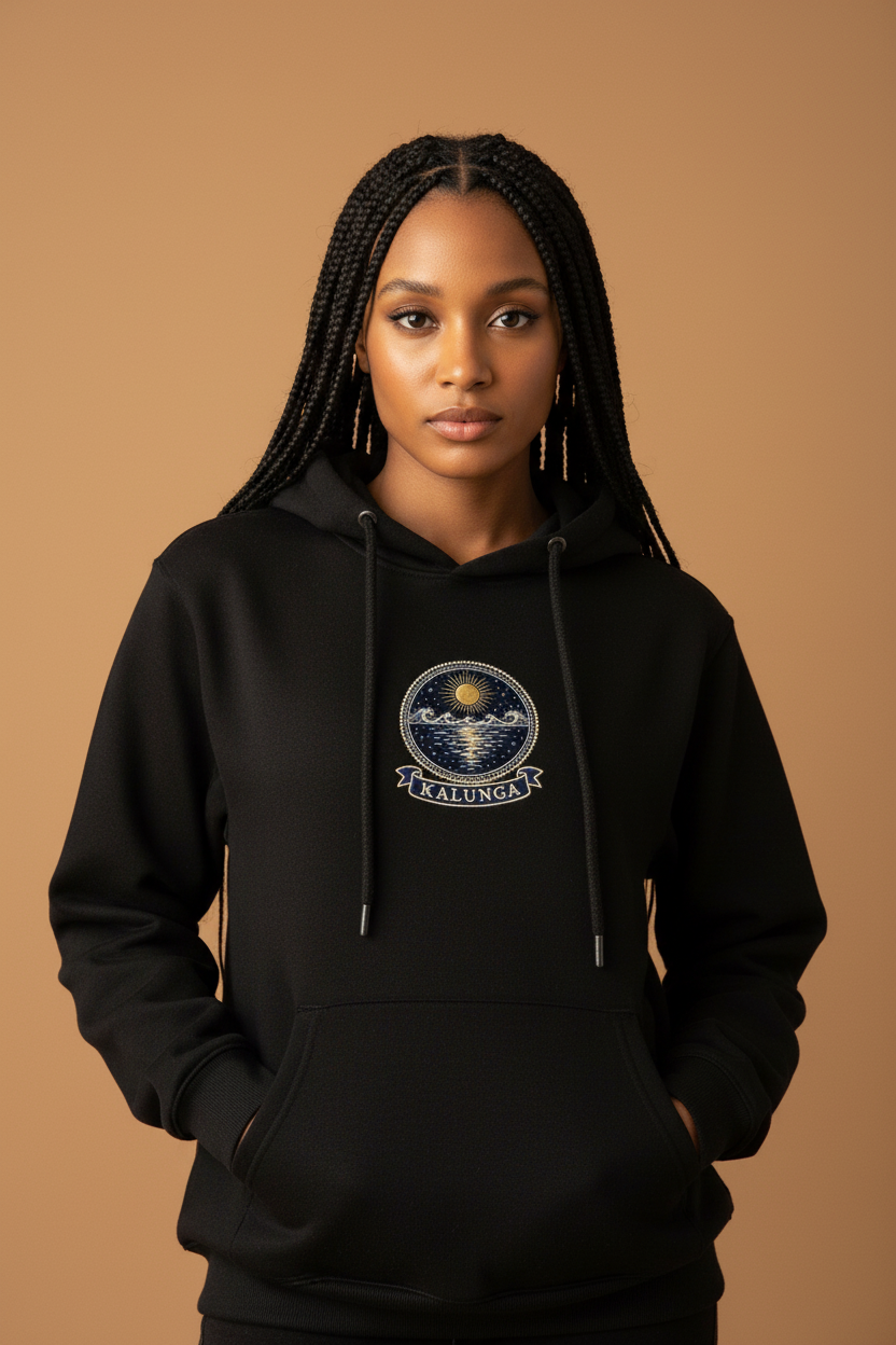 Kalunga jet black hoodie worn by a model, embroidery-style Kongo emblem printed as a chest crest, Dikenga Collection by Bana Bilaka