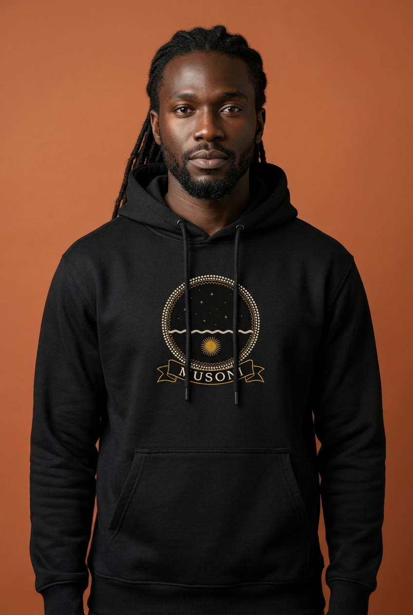 Musoni jet black hoodie worn by a model, embroidery-style Kongo emblem printed as a chest crest, Dikenga Collection by Bana Bilaka