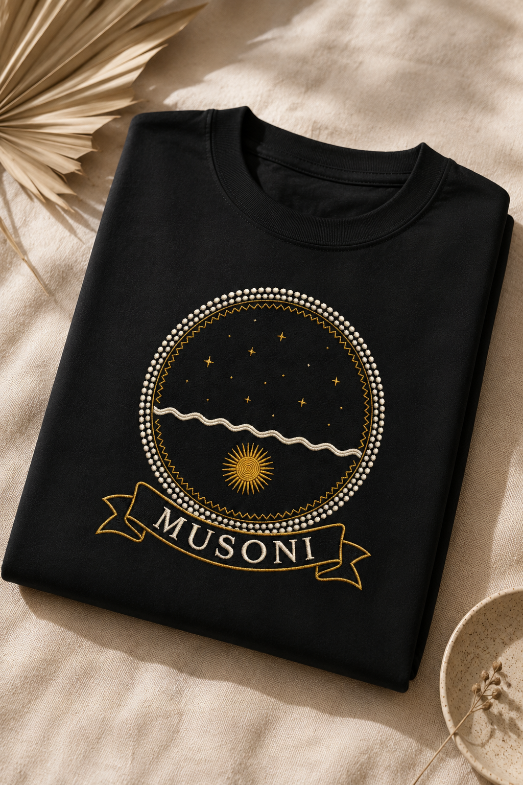 Musoni black tee flat-lay on linen, Dikenga Collection by Bana Bilaka